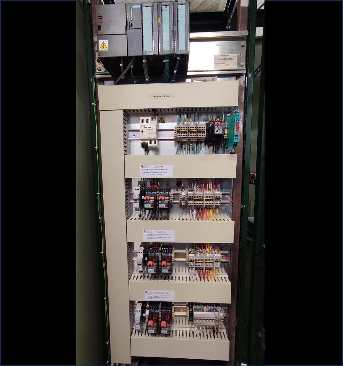 This photo shows the control circuits for the NA62 CEDAR. At the top, in black, you can see a programmable logic controller (PLC). The PLC provides and controls the voltage sent to the various motors of the CEDAR, and reads and interprets the values of several sensors.