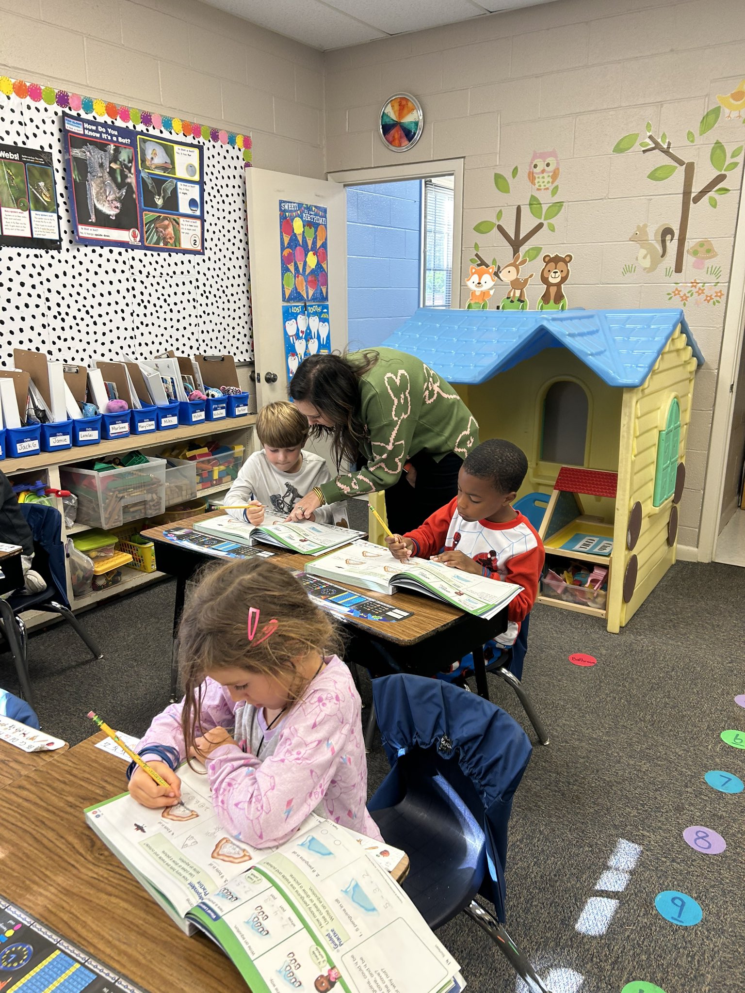 Mrs. Shea helps students in first grade