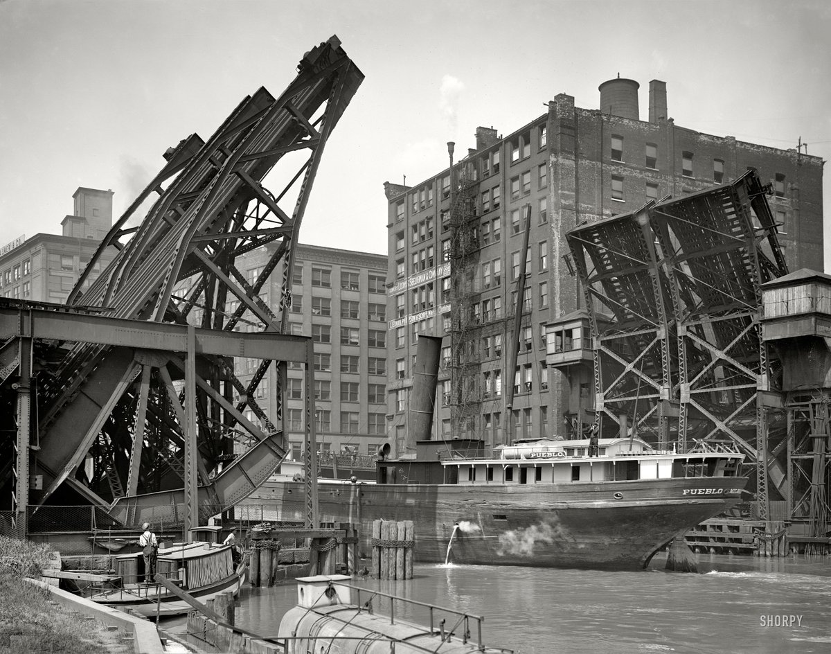 Chicago, Illinois, circa 1907. 'Jackknife Bridge, Chicago River.' The Pueblo passing through the open span. Glass negative by Hans Behm. #chicagohistory #chicago #historicphotography #ENC