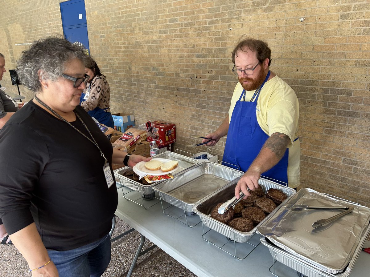AHSTrojansAISD's tweet photo. What do you all do when you have four hours of PSAT and SPED training? How about a cookout with admin serving the teachers? Good times, good food, good people! @Secondary_AISD #OneAnderson https://t.co/VJ7lggWncK