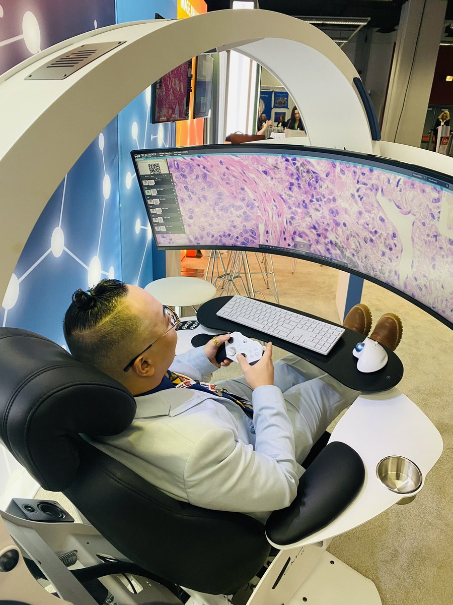 The future of #Pathology is here! Tried this at #CAP23. Super comfy ergonomic chair with a giant curved top of the line screen for viewing digital slides that you can scan and zoom in and out of using a remote control! #IndicaLabs #SantaIWantOneForChristmas