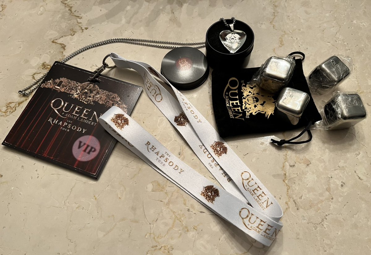 LambertizeMe's tweet photo. VIP swag bag - spoiler alert. This is with the Killer Queen package. The necklace is beautiful. It says Queen on one side, with logo, and Rhapsody Tour 2023 on the other. Nice weight. The cubes are to freeze and use in drinks. Thoughtful gifts IMO. #QueenVIP #queenandadamlambert https://t.co/fNSBcQ3XoF