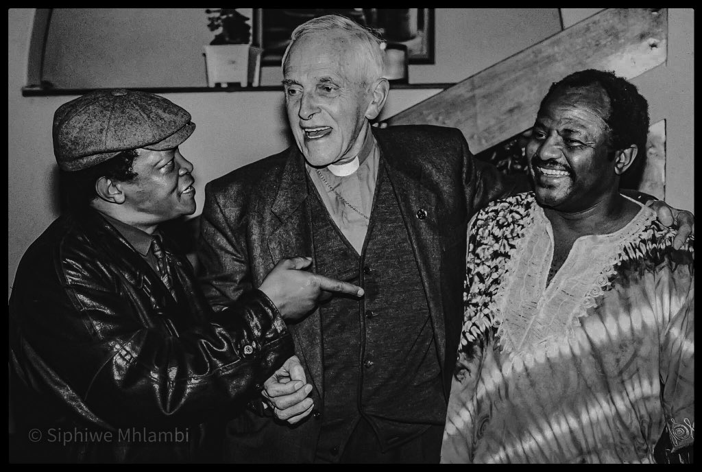 Meeting of the legends! 
#FatherTrevorHuddleston, priest, human rights activist, and leader in the anti-apartheid movement, provided #HughMasekela with his first trumpet as a 14-year-old pupil. I shot this pic in 1992 at Dr. Jiyana Mgojo Mbere’s residence (far right).
