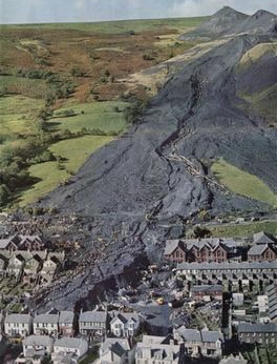MorbidKnowledge's tweet photo. The Aberfan disaster occurred on October 21, 1966, when a colliery spoil tip tragically collapsed. This tip had been formed on a mountain slope above the Welsh village of Aberfan, near Merthyr Tydfil, and it covered a natural spring.

Intense rainfall resulted in water accumulating within the tip, causing it to swiftly slide downhill as a slurry. This devastating event claimed the lives of 116 children and 28 adults as it engulfed Pantglas Junior School and a row of houses.