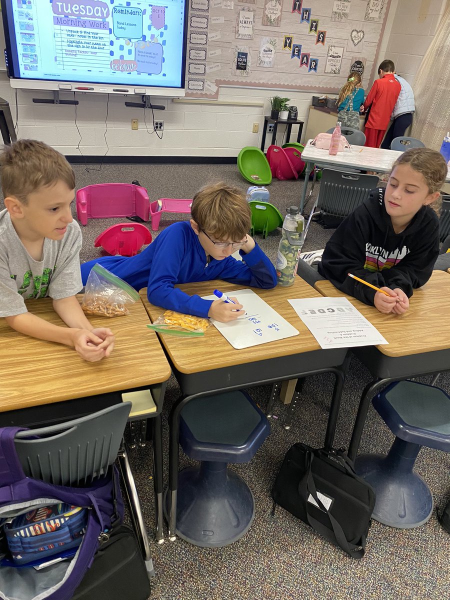 Starting the day with some deep math thinking in groups of 3!