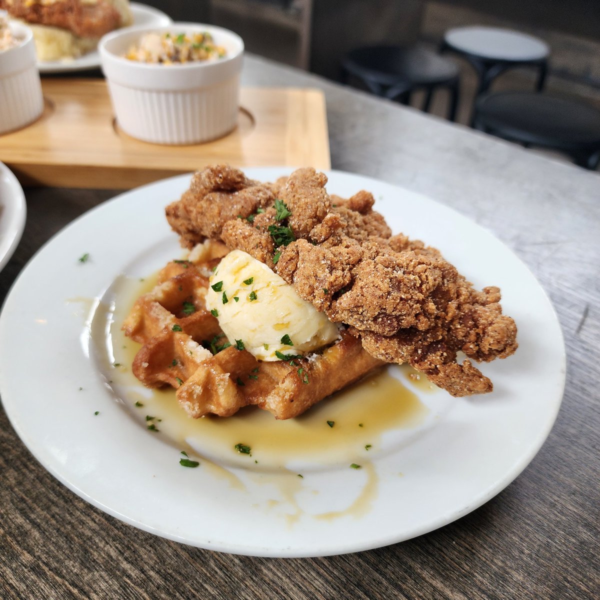 Chicken and Waffle is back! Crispy fried chicken on a Belgian pearled sugar waffle with honey butter and bourbon cane syrup.