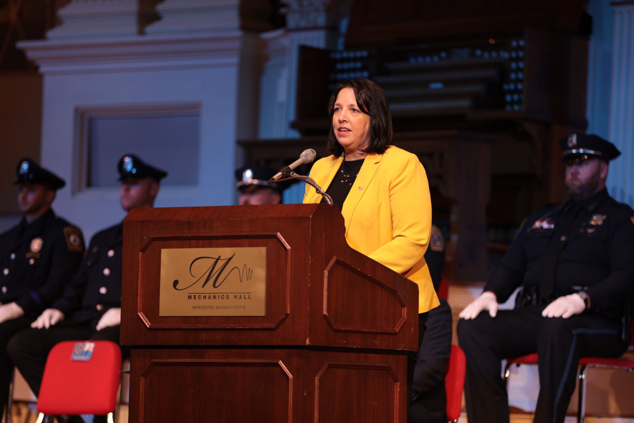 LG Driscoll at podium with police officers behind her.