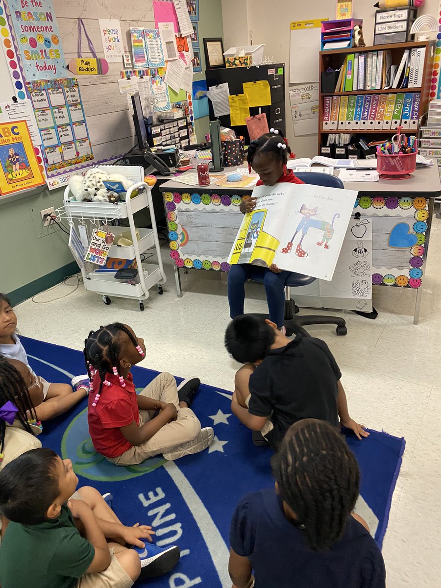 MissRandolphK's tweet photo. Our teacher helper Loven stepped up and lead today during our reading lesson with the story “Pete the Cat Too Cool for School”. She asked to help hold the book and point to the words as we echo read the story together! 📚@hceotters #kindercrew #readingisfun https://t.co/n3n063Wyhb