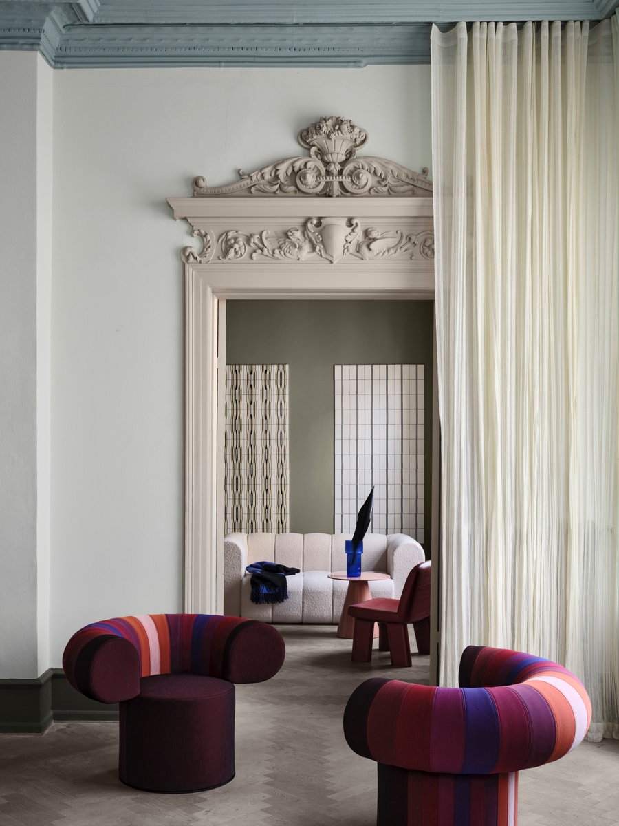 Big Talk- a true conversation piece. A manifest in geometry: two circles define a throne for the art of sitting. The front part of the backrest and the seat shine in the same colour, whereas the back can be combined with textile swatches in a colour book format,