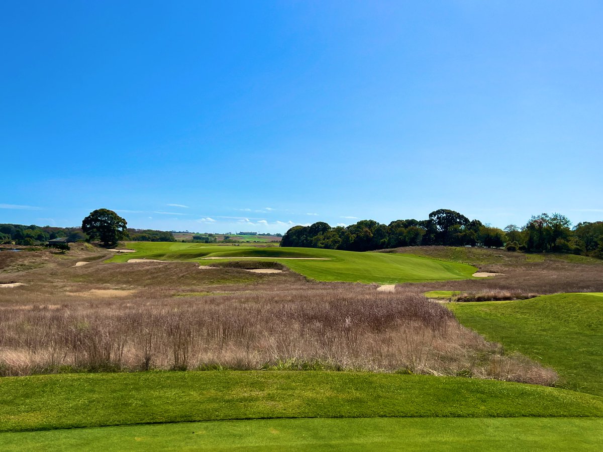 GCAJoeA's tweet photo. National Golf Links of America
1908 C.B. Macdonald

Macdonald set out on a mission to build a golf course that would resemble the greats of the British Isles. CB found a piece of property on the Peconic Bay of Long Island and with the help of a local engineer, Seth Raynor, the two crafted an architectural masterpiece.

NGLA, weaves you out towards its next door neighbor, Shinnecock Hills, and then back to the clubhouse which sits atop a hill overlooking the Peconic Bay. The holes each have their own personal characteristics - some with massive Sahara bunkers, some with tiny pot bunkers, greens that are plateaued, thumb printed and punchbowled. The fairways are firm and fast, guarded by native fescue areas and the greens roll like table tops.

“National” as it is affectionately called, is as fun to play as any. Each hole tells a new story and the walk out and back is one of the most enjoyable you’ll ever take on a golf course. Today was a dream for me - it was utter bliss. The weather was 65 and sun and just the right amount of wind. If there is a heaven on earth, I believe I was there today.