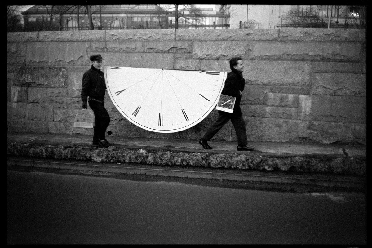Sometimes you find these unique moments. Sequels #147-Half antique clock being carried by two men with bird cages, NYC, 1965