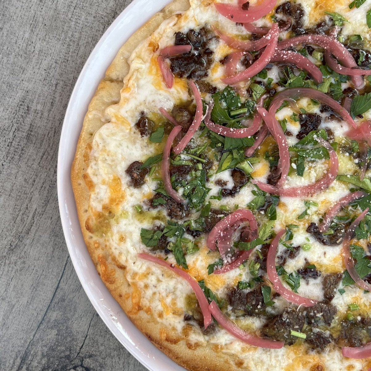 JT_Schmids's tweet photo. Not your original ‘za! 🍕 Spice things up with our Carne Asada Pizza featuring house cream sauce, mozzarella and cheddar blend, green salsa, picked red onions, cilantro, cotija cheese, and carne asada. https://t.co/44Ji16yB9X