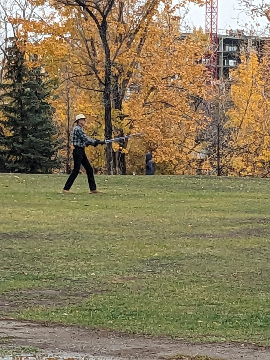 gkmaitland's tweet photo. There is a man practicing swordfighting with a longsword in the park next to my house in the rain and wearing that hat. I won't lie, I'm scared; not of him, but by what he must know is coming. https://t.co/z2VbYThf06