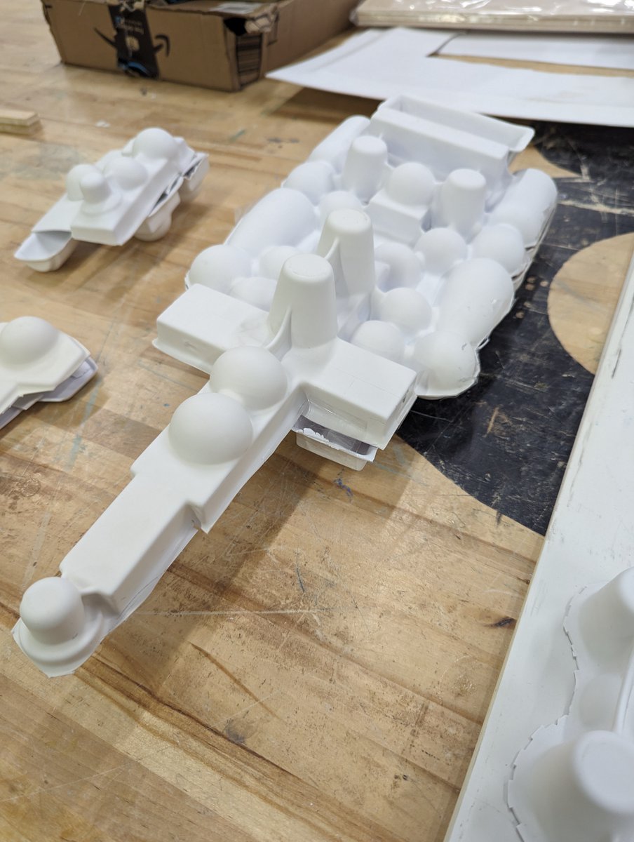 novysan's tweet photo. Lunar Base One, transport vessel, and a small fighter craft coming together, hot off the vacuu-former and ready for layers and layers of greebles. Teaching our @carsoncenterunl  students the old magics. #DigiFab #VFX #Storytelling #PracticalEffects https://t.co/xzSNbXtxzX