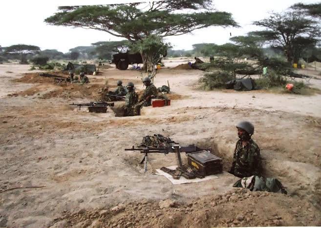 AssegaiConsult's tweet photo. BATTLE OF HOSINGOW: HOW OUTNUMBERED KDF COMPANY FOUGHT OFF Al SHABAAB ATTACKERS 

January 14th 2018

The Standard

April 4, 2012. A day that will forever be etched in Al Shabaab history as their day of reckoning.

What was supposed to be Al Shabaab’s best planned attack on a Kenya Defence Force (KDF) position in Somalia miserably failed and led to the massacre of a large number of the militants.

On this day, Al Shabaab lost more than 400 of their fighters in Hosingow, the largest number of casualties suffered in the hands of KDF troops.

What Al Shabaab had expected to be an easy overrunning of the KDF camp in Hosingow turned out to be their Waterloo. A nightmare.

By the end of that day, hundreds of bodies lay strewn around the KDF camp. Each of the slain attackers had a blue plastic cup, presumably for a hefty breakfast they hoped to have after overrunning the camp.

Elite Al Shabaab fighters, who had all along been depicted as relentless and unbeatable, had bragged that the attack would go down as the best planned and organised.
It involved a battalion of more than 1,000 attackers.

They attacked the camp in groups of 100 soldiers each, sending them to their deaths every 45 minutes. Eleven hours later, the terror group had lost almost half of its fighters in what they thought was a small camp could easily be overrun.

Al Shabaab had been planning the attack by amassing equipment and fighters in Hinday, to the East of Hosingow and about 40 kilometers from the camp, for over a month. Some of the fighters had been arriving on foot.

Intelligence gathered by KDF and the Somalia National Army (SNA) indicated that the militants had assembled several troop transporting vehicles, Dushka guns and more than 1,000 fighters in preparation for the attack.

“We were reliably informed that this was an elite unit planning an attack on our camp. There were between 800 and 1,000 Al Shabaab fighters. We knew we were going to be under attack within 24 hours,” Major Hillary Busienei, who was second in command of the unit that had liberated Hosingow two months earlier recalled.

The attack was expected late in the night or early in the morning when sentries are least alert. But KDF soldiers who had conducted a reconnaissance mission earlier were prepared for it.

That evening, Sergeant Major Robert Nyagah, the warrant officer in charge of ammunition distribution, saw it fit to give out all ammunition, mortar bombs and grenades to soldiers in their positions prior to the attack.

The standard practice would be for him to regularly run around positions, ducking mortars and bullets as he replenished ammunition to soldiers who had run out of them. Not this day. His instincts urged him to hand over all ammunition to all soldiers prior to the attack.

This move saved the situation on that fateful day. There had been no time to replenish. Soldiers took their positions that evening and lay in wait for the attackers.

At about 4:30am, a KDF soldier tripped on one of the flares, and as if by cue triggered sporadic shooting around the camp.

“I did not close my eyes, I guess it was due to the adrenaline. We took turns to rest in shifts and took positions earlier than normal. As early as 10pm, the trip flares began going off and we knew that the enemy was conducting their reconnaissance. This went on until morning when one of the soldiers set off the signal flare,” Major Busienei, who was second in command at the camp recalls.

All hell broke loose as the rat-a-tat of gunfire, booms of mortar and other weapons rent the air as the attackers attempted to run into the camp.

KDF soldiers who had been all along waiting for the attackers responded to the attack with their own fire power. Lance Corporal Kemboi and Senior Sergeant Ekal hit the attackers with their initial first response. They hit selected targets of the frontal attack with mortar bombs supported by their colleagues in the trenches.

This destroyed Al Shabaab’s initial attack. The attackers would come in a group of about 100 and sustain an attack until they ran out of ammunition or were killed before the second group arrived. Each attack took about 45 minutes.

“Their intention was to get us to exhaust our ammunition, but we held them as we waited for reinforcements from Tabda and Liboi. I then realised that we had a problem with communication between our commander and the commander of the Panhead. I decided to risk it and make a 30 metre dash to my commander’s position to confirm that our grid had been correctly given. The attackers were pinning us down with Dushkas,” Major Busienei recalls.

For hours, the KDF soldiers kept the attackers at bay.

An F5 jet fighter then flew right above the camp, but the pilot could not fire at the attackers as they were too close to the KDF positions. On his second attempt, he struck an Al Shabaab position.

Meanwhile, five Al Shabaab fighters had crawled to within 20 metres of the trench in which five Kenyan soldiers had taken position.

The five KDF soldiers patiently waited for the attackers to move closer to within range before they could use their only remaining weapons — hand grenades — at the advancing enemy. Their G3 rifles had jammed after hours of continuous firing.

A KDF driver in an Armored Personnel Carrier (APC) stationed at another location noticed the attackers crawling towards the trench and decided to run them over before they could reach the five soldiers.

But as he did so, his vehicle’s fuel tank was shot at and pierced. The APC was again hit by an armor piercing as he drove back to his position. The bullet hit and injured the driver.

Another KDF vehicle was also shot at by the same weapon just as the attackers were giving up hope of overrunning the camp.

Shortly thereafter, precisely at 10:30am, two Kenya Air Force 50 ACB helicopters flew low over the camp to assess the situation before taking another loop during which they destroyed several of the attackers’ technicals.

Despite coming under attack, a daring KDF pilot (only identified as Chemirmir) landed his attack helicopter at the camp to touch base with his colleagues who had been under fire for hours. The pilot bore good news for the tired KDF soldiers. Despite their superior numbers, the enemy was retreating.

He advised the fighting soldiers to pursue the enemy, but the KDF command decided against it because it would expose them.
The helicopter yet again came under attack when it took off, but was not hit. The pilot landed at the camp again to check for any damage of the aircraft before taking off to reload in Liboi.

By this time, the enemy fire had retreated and the KDF soldiers in the camp could now move around. After hours of fighting, the soldiers just wanted to hear their commanders’ voice for reassurance.

At 11:00am some SNA soldiers who had been fighting alongside their KDF colleagues decided to check on casualties but came under attack. Three of them were killed and six others injured.

Shortly thereafter, reports came in that a KDF corporal had fallen and injured his hip. Five KDF soldiers were injured during the fighting. By then, nobody knew if any KDF soldier had been killed.

The soldiers then moved out to conduct patrols around the camp and were shocked at the extent of the damage. Human flesh and body parts were strewn all over. The enemy’s first aid location had been hit by KDF’s mortars and and its re-supply location destroyed by bombs.

Fifty enemy bodies were collected in the immediate vicinity of the camp. Many more bodies had been dragged away by the retreating Al Shabaab fighters, who rarely abandon their dead. All the dead attackers had blue plastic cups on them.

“At 2.30pm, a helicopter arrived to evacuate the casualties. At 3pm, we went back to our positions. It is only then that we realised we had not eaten the whole day, but no one had the appetite. We organised for a light meal,” he recalled.

Busienei reckons that their training before deployment to Somalia and comradeship saved the day.