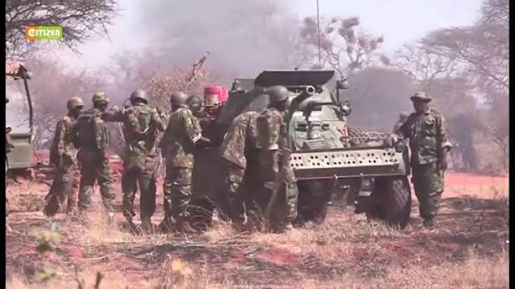 AssegaiConsult's tweet photo. BATTLE OF HOSINGOW: HOW OUTNUMBERED KDF COMPANY FOUGHT OFF Al SHABAAB ATTACKERS 

January 14th 2018

The Standard

April 4, 2012. A day that will forever be etched in Al Shabaab history as their day of reckoning.

What was supposed to be Al Shabaab’s best planned attack on a Kenya Defence Force (KDF) position in Somalia miserably failed and led to the massacre of a large number of the militants.

On this day, Al Shabaab lost more than 400 of their fighters in Hosingow, the largest number of casualties suffered in the hands of KDF troops.

What Al Shabaab had expected to be an easy overrunning of the KDF camp in Hosingow turned out to be their Waterloo. A nightmare.

By the end of that day, hundreds of bodies lay strewn around the KDF camp. Each of the slain attackers had a blue plastic cup, presumably for a hefty breakfast they hoped to have after overrunning the camp.

Elite Al Shabaab fighters, who had all along been depicted as relentless and unbeatable, had bragged that the attack would go down as the best planned and organised.
It involved a battalion of more than 1,000 attackers.

They attacked the camp in groups of 100 soldiers each, sending them to their deaths every 45 minutes. Eleven hours later, the terror group had lost almost half of its fighters in what they thought was a small camp could easily be overrun.

Al Shabaab had been planning the attack by amassing equipment and fighters in Hinday, to the East of Hosingow and about 40 kilometers from the camp, for over a month. Some of the fighters had been arriving on foot.

Intelligence gathered by KDF and the Somalia National Army (SNA) indicated that the militants had assembled several troop transporting vehicles, Dushka guns and more than 1,000 fighters in preparation for the attack.

“We were reliably informed that this was an elite unit planning an attack on our camp. There were between 800 and 1,000 Al Shabaab fighters. We knew we were going to be under attack within 24 hours,” Major Hillary Busienei, who was second in command of the unit that had liberated Hosingow two months earlier recalled.

The attack was expected late in the night or early in the morning when sentries are least alert. But KDF soldiers who had conducted a reconnaissance mission earlier were prepared for it.

That evening, Sergeant Major Robert Nyagah, the warrant officer in charge of ammunition distribution, saw it fit to give out all ammunition, mortar bombs and grenades to soldiers in their positions prior to the attack.

The standard practice would be for him to regularly run around positions, ducking mortars and bullets as he replenished ammunition to soldiers who had run out of them. Not this day. His instincts urged him to hand over all ammunition to all soldiers prior to the attack.

This move saved the situation on that fateful day. There had been no time to replenish. Soldiers took their positions that evening and lay in wait for the attackers.

At about 4:30am, a KDF soldier tripped on one of the flares, and as if by cue triggered sporadic shooting around the camp.

“I did not close my eyes, I guess it was due to the adrenaline. We took turns to rest in shifts and took positions earlier than normal. As early as 10pm, the trip flares began going off and we knew that the enemy was conducting their reconnaissance. This went on until morning when one of the soldiers set off the signal flare,” Major Busienei, who was second in command at the camp recalls.

All hell broke loose as the rat-a-tat of gunfire, booms of mortar and other weapons rent the air as the attackers attempted to run into the camp.

KDF soldiers who had been all along waiting for the attackers responded to the attack with their own fire power. Lance Corporal Kemboi and Senior Sergeant Ekal hit the attackers with their initial first response. They hit selected targets of the frontal attack with mortar bombs supported by their colleagues in the trenches.

This destroyed Al Shabaab’s initial attack. The attackers would come in a group of about 100 and sustain an attack until they ran out of ammunition or were killed before the second group arrived. Each attack took about 45 minutes.

“Their intention was to get us to exhaust our ammunition, but we held them as we waited for reinforcements from Tabda and Liboi. I then realised that we had a problem with communication between our commander and the commander of the Panhead. I decided to risk it and make a 30 metre dash to my commander’s position to confirm that our grid had been correctly given. The attackers were pinning us down with Dushkas,” Major Busienei recalls.

For hours, the KDF soldiers kept the attackers at bay.

An F5 jet fighter then flew right above the camp, but the pilot could not fire at the attackers as they were too close to the KDF positions. On his second attempt, he struck an Al Shabaab position.

Meanwhile, five Al Shabaab fighters had crawled to within 20 metres of the trench in which five Kenyan soldiers had taken position.

The five KDF soldiers patiently waited for the attackers to move closer to within range before they could use their only remaining weapons — hand grenades — at the advancing enemy. Their G3 rifles had jammed after hours of continuous firing.

A KDF driver in an Armored Personnel Carrier (APC) stationed at another location noticed the attackers crawling towards the trench and decided to run them over before they could reach the five soldiers.

But as he did so, his vehicle’s fuel tank was shot at and pierced. The APC was again hit by an armor piercing as he drove back to his position. The bullet hit and injured the driver.

Another KDF vehicle was also shot at by the same weapon just as the attackers were giving up hope of overrunning the camp.

Shortly thereafter, precisely at 10:30am, two Kenya Air Force 50 ACB helicopters flew low over the camp to assess the situation before taking another loop during which they destroyed several of the attackers’ technicals.

Despite coming under attack, a daring KDF pilot (only identified as Chemirmir) landed his attack helicopter at the camp to touch base with his colleagues who had been under fire for hours. The pilot bore good news for the tired KDF soldiers. Despite their superior numbers, the enemy was retreating.

He advised the fighting soldiers to pursue the enemy, but the KDF command decided against it because it would expose them.
The helicopter yet again came under attack when it took off, but was not hit. The pilot landed at the camp again to check for any damage of the aircraft before taking off to reload in Liboi.

By this time, the enemy fire had retreated and the KDF soldiers in the camp could now move around. After hours of fighting, the soldiers just wanted to hear their commanders’ voice for reassurance.

At 11:00am some SNA soldiers who had been fighting alongside their KDF colleagues decided to check on casualties but came under attack. Three of them were killed and six others injured.

Shortly thereafter, reports came in that a KDF corporal had fallen and injured his hip. Five KDF soldiers were injured during the fighting. By then, nobody knew if any KDF soldier had been killed.

The soldiers then moved out to conduct patrols around the camp and were shocked at the extent of the damage. Human flesh and body parts were strewn all over. The enemy’s first aid location had been hit by KDF’s mortars and and its re-supply location destroyed by bombs.

Fifty enemy bodies were collected in the immediate vicinity of the camp. Many more bodies had been dragged away by the retreating Al Shabaab fighters, who rarely abandon their dead. All the dead attackers had blue plastic cups on them.

“At 2.30pm, a helicopter arrived to evacuate the casualties. At 3pm, we went back to our positions. It is only then that we realised we had not eaten the whole day, but no one had the appetite. We organised for a light meal,” he recalled.

Busienei reckons that their training before deployment to Somalia and comradeship saved the day.