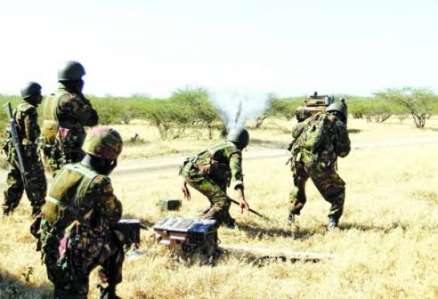 AssegaiConsult's tweet photo. BATTLE OF HOSINGOW: HOW OUTNUMBERED KDF COMPANY FOUGHT OFF Al SHABAAB ATTACKERS 

January 14th 2018

The Standard

April 4, 2012. A day that will forever be etched in Al Shabaab history as their day of reckoning.

What was supposed to be Al Shabaab’s best planned attack on a Kenya Defence Force (KDF) position in Somalia miserably failed and led to the massacre of a large number of the militants.

On this day, Al Shabaab lost more than 400 of their fighters in Hosingow, the largest number of casualties suffered in the hands of KDF troops.

What Al Shabaab had expected to be an easy overrunning of the KDF camp in Hosingow turned out to be their Waterloo. A nightmare.

By the end of that day, hundreds of bodies lay strewn around the KDF camp. Each of the slain attackers had a blue plastic cup, presumably for a hefty breakfast they hoped to have after overrunning the camp.

Elite Al Shabaab fighters, who had all along been depicted as relentless and unbeatable, had bragged that the attack would go down as the best planned and organised.
It involved a battalion of more than 1,000 attackers.

They attacked the camp in groups of 100 soldiers each, sending them to their deaths every 45 minutes. Eleven hours later, the terror group had lost almost half of its fighters in what they thought was a small camp could easily be overrun.

Al Shabaab had been planning the attack by amassing equipment and fighters in Hinday, to the East of Hosingow and about 40 kilometers from the camp, for over a month. Some of the fighters had been arriving on foot.

Intelligence gathered by KDF and the Somalia National Army (SNA) indicated that the militants had assembled several troop transporting vehicles, Dushka guns and more than 1,000 fighters in preparation for the attack.

“We were reliably informed that this was an elite unit planning an attack on our camp. There were between 800 and 1,000 Al Shabaab fighters. We knew we were going to be under attack within 24 hours,” Major Hillary Busienei, who was second in command of the unit that had liberated Hosingow two months earlier recalled.

The attack was expected late in the night or early in the morning when sentries are least alert. But KDF soldiers who had conducted a reconnaissance mission earlier were prepared for it.

That evening, Sergeant Major Robert Nyagah, the warrant officer in charge of ammunition distribution, saw it fit to give out all ammunition, mortar bombs and grenades to soldiers in their positions prior to the attack.

The standard practice would be for him to regularly run around positions, ducking mortars and bullets as he replenished ammunition to soldiers who had run out of them. Not this day. His instincts urged him to hand over all ammunition to all soldiers prior to the attack.

This move saved the situation on that fateful day. There had been no time to replenish. Soldiers took their positions that evening and lay in wait for the attackers.

At about 4:30am, a KDF soldier tripped on one of the flares, and as if by cue triggered sporadic shooting around the camp.

“I did not close my eyes, I guess it was due to the adrenaline. We took turns to rest in shifts and took positions earlier than normal. As early as 10pm, the trip flares began going off and we knew that the enemy was conducting their reconnaissance. This went on until morning when one of the soldiers set off the signal flare,” Major Busienei, who was second in command at the camp recalls.

All hell broke loose as the rat-a-tat of gunfire, booms of mortar and other weapons rent the air as the attackers attempted to run into the camp.

KDF soldiers who had been all along waiting for the attackers responded to the attack with their own fire power. Lance Corporal Kemboi and Senior Sergeant Ekal hit the attackers with their initial first response. They hit selected targets of the frontal attack with mortar bombs supported by their colleagues in the trenches.

This destroyed Al Shabaab’s initial attack. The attackers would come in a group of about 100 and sustain an attack until they ran out of ammunition or were killed before the second group arrived. Each attack took about 45 minutes.

“Their intention was to get us to exhaust our ammunition, but we held them as we waited for reinforcements from Tabda and Liboi. I then realised that we had a problem with communication between our commander and the commander of the Panhead. I decided to risk it and make a 30 metre dash to my commander’s position to confirm that our grid had been correctly given. The attackers were pinning us down with Dushkas,” Major Busienei recalls.

For hours, the KDF soldiers kept the attackers at bay.

An F5 jet fighter then flew right above the camp, but the pilot could not fire at the attackers as they were too close to the KDF positions. On his second attempt, he struck an Al Shabaab position.

Meanwhile, five Al Shabaab fighters had crawled to within 20 metres of the trench in which five Kenyan soldiers had taken position.

The five KDF soldiers patiently waited for the attackers to move closer to within range before they could use their only remaining weapons — hand grenades — at the advancing enemy. Their G3 rifles had jammed after hours of continuous firing.

A KDF driver in an Armored Personnel Carrier (APC) stationed at another location noticed the attackers crawling towards the trench and decided to run them over before they could reach the five soldiers.

But as he did so, his vehicle’s fuel tank was shot at and pierced. The APC was again hit by an armor piercing as he drove back to his position. The bullet hit and injured the driver.

Another KDF vehicle was also shot at by the same weapon just as the attackers were giving up hope of overrunning the camp.

Shortly thereafter, precisely at 10:30am, two Kenya Air Force 50 ACB helicopters flew low over the camp to assess the situation before taking another loop during which they destroyed several of the attackers’ technicals.

Despite coming under attack, a daring KDF pilot (only identified as Chemirmir) landed his attack helicopter at the camp to touch base with his colleagues who had been under fire for hours. The pilot bore good news for the tired KDF soldiers. Despite their superior numbers, the enemy was retreating.

He advised the fighting soldiers to pursue the enemy, but the KDF command decided against it because it would expose them.
The helicopter yet again came under attack when it took off, but was not hit. The pilot landed at the camp again to check for any damage of the aircraft before taking off to reload in Liboi.

By this time, the enemy fire had retreated and the KDF soldiers in the camp could now move around. After hours of fighting, the soldiers just wanted to hear their commanders’ voice for reassurance.

At 11:00am some SNA soldiers who had been fighting alongside their KDF colleagues decided to check on casualties but came under attack. Three of them were killed and six others injured.

Shortly thereafter, reports came in that a KDF corporal had fallen and injured his hip. Five KDF soldiers were injured during the fighting. By then, nobody knew if any KDF soldier had been killed.

The soldiers then moved out to conduct patrols around the camp and were shocked at the extent of the damage. Human flesh and body parts were strewn all over. The enemy’s first aid location had been hit by KDF’s mortars and and its re-supply location destroyed by bombs.

Fifty enemy bodies were collected in the immediate vicinity of the camp. Many more bodies had been dragged away by the retreating Al Shabaab fighters, who rarely abandon their dead. All the dead attackers had blue plastic cups on them.

“At 2.30pm, a helicopter arrived to evacuate the casualties. At 3pm, we went back to our positions. It is only then that we realised we had not eaten the whole day, but no one had the appetite. We organised for a light meal,” he recalled.

Busienei reckons that their training before deployment to Somalia and comradeship saved the day.