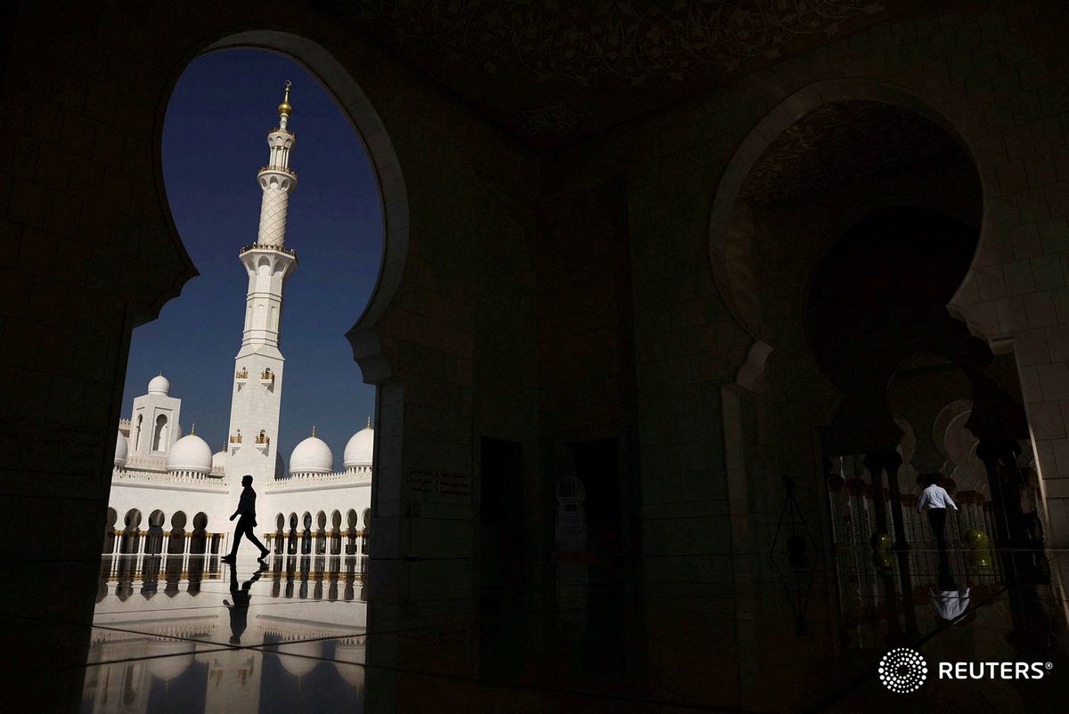 People walk at the Sheikh Zayed Grand Mosque in Abu Dhabi, Oct. 12, 2023. — <a href="/Reuters/">Reuters</a>