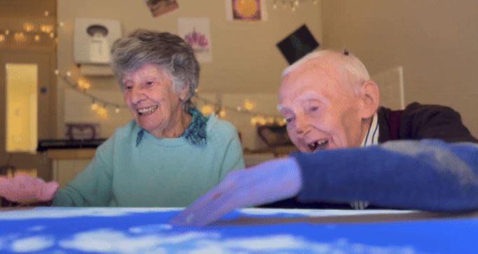 BoardGwent's tweet image. The #HappinessProgramme uses technology that   helps stimulate movement and interaction, reduce falls, improve sleep,   enhance emotional well-being and create shared experiences for loved ones and   the people who care for them. All through interactive games!
