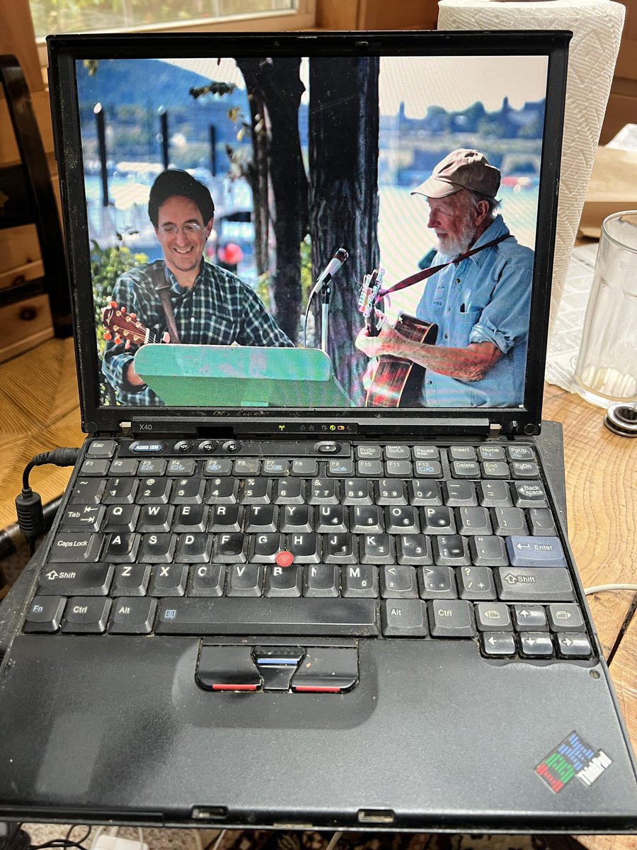 Revkin's tweet image. Opening an ancient ThinkPad that’s been in a box for 15 years is a ghostly experience. Wallpaper is me singing with Pete Seeger. One of the last emails., 12/5/2007, is “climate bill moves to Senate floor”….  #oldtech