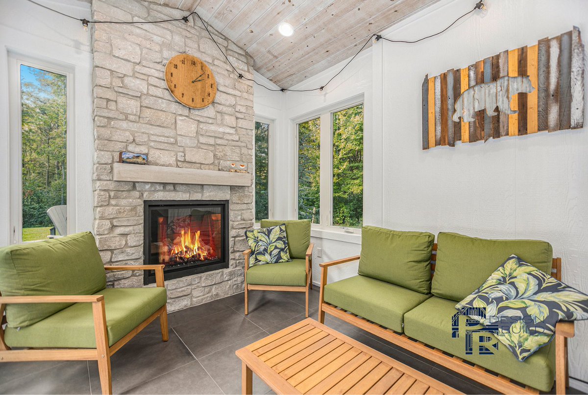 PRDesignBuild's tweet photo. Introducing our latest project reveal - a stunning covered porch, a cozy 3-season room with a double-sided fireplace, a patio with porcelain pavers, and a fully equipped outdoor kitchen. 
Explore more at https://t.co/0MJYWVd4ns. #PRDesignBuild #HollandMI #LuxuryLiving https://t.co/kjFMBBCqO3