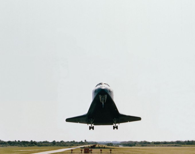 Space shuttle just before landing on a runway, taken from slightly below the shuttle.