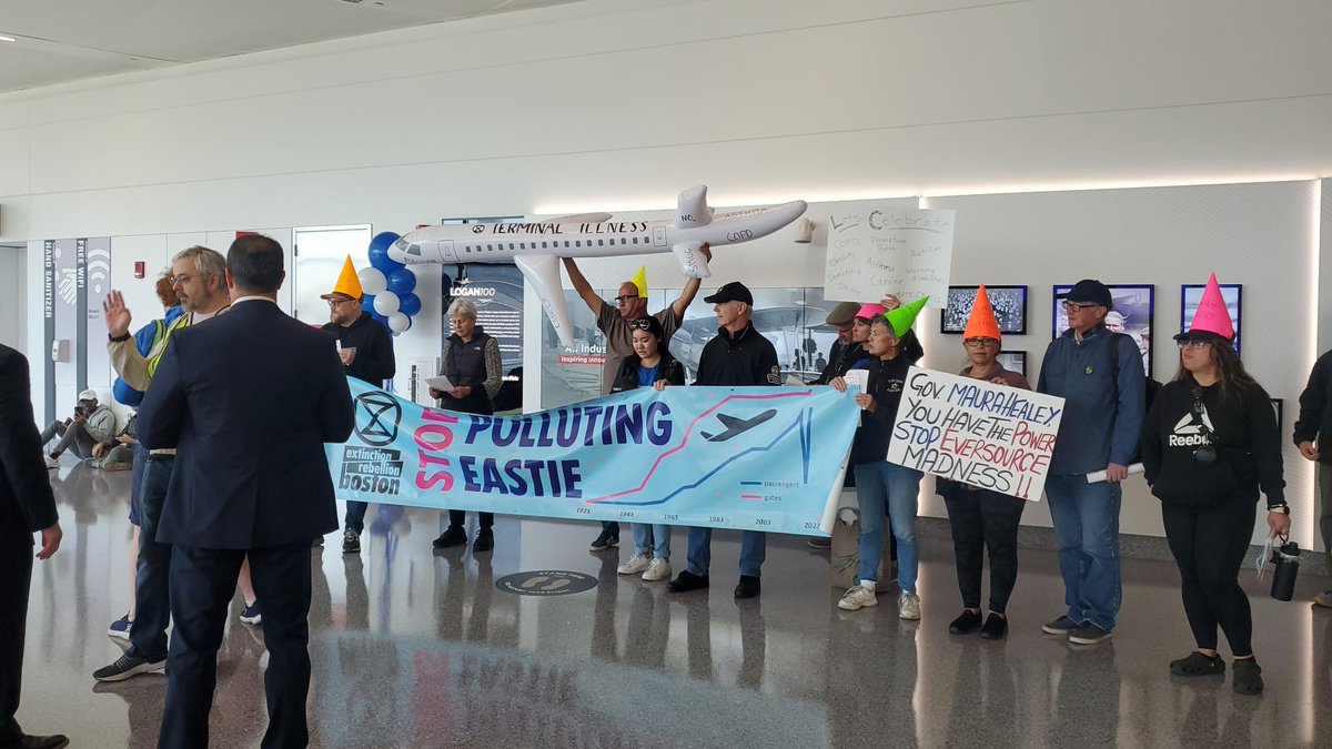 XRBoston's tweet photo. 🚨BREAKING NEWS: Climate activists are disrupting the @BostonLogan 100th Anniversary celebration, demanding @Massport compensate East Boston residents for health impacts and #StopPollutingEastie 
Full press release here: https://t.co/sdP8OeRhDu https://t.co/wlEiTFJe0H