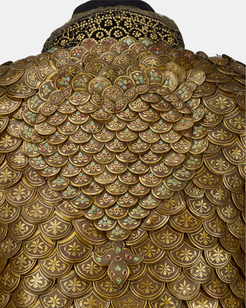 Detail of the coat of scale armour that was presented to King Edward VII during his tour of India in 1875-76 by Bhavani Singh, Maharaja of Datia. Made of Pangolin scales, gilt copper, velvet, gold, turquoises, rubies, ivory, glass beads and pearls. Royal Collection Trust