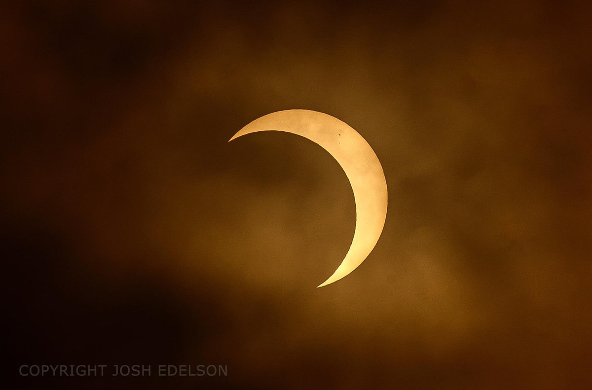 For a brief moment, the clouds cleared and we got a view of the partial annular solar eclipse a few minutes ago. This is from northern California at around 76% coverage. #Eclipse