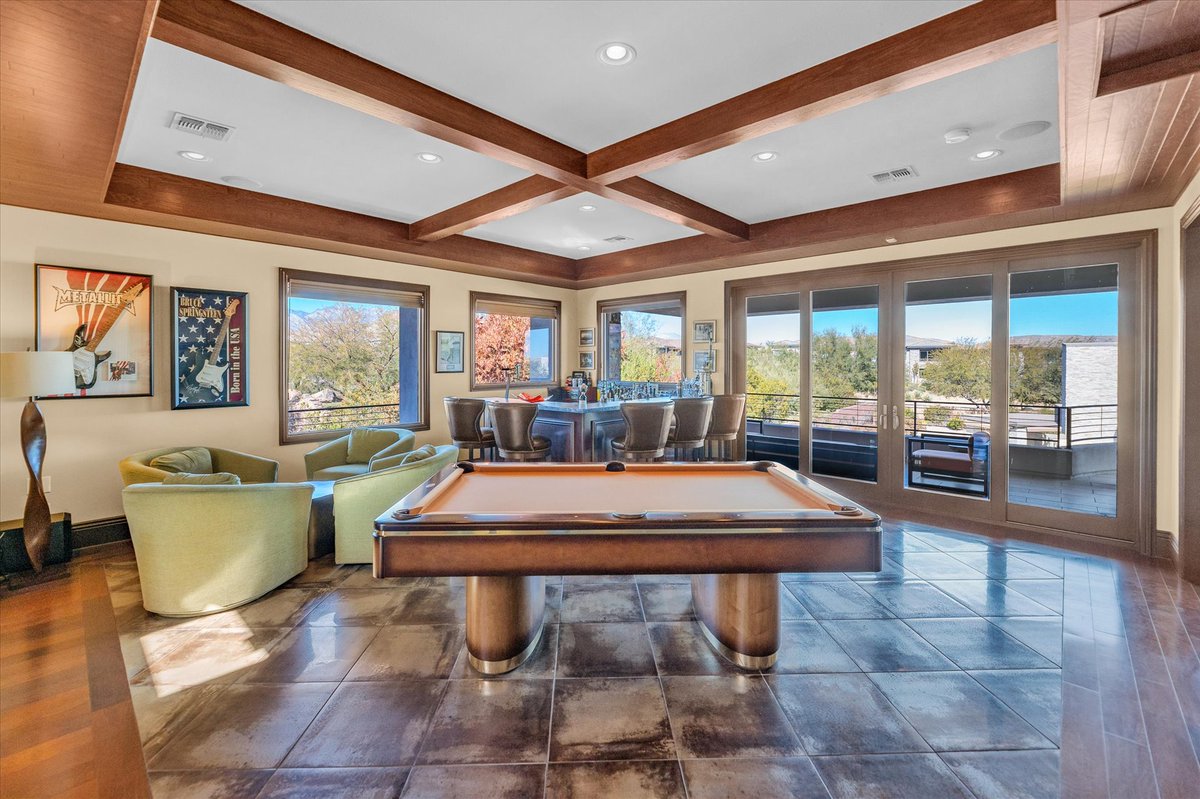 This game room features a five-seat wet bar, surround sound, and an expansive wraparound balcony with mountain, city, and Strip views 🙌🏼 #22DriftingShadow • The Ridges • $4,500,000 4,734 SF • 4 Beds • 6 Baths • Pool & Spa ML#2468855