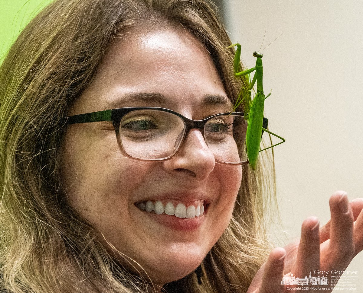 A praying mantis intended to mesmerize children attending BUG OUT show at the Westerville Library climbs the face of a librarian who chose to help manage the insect during a break in the show. My Final Photo for October 14, 2023. bit.ly/3Fezdds