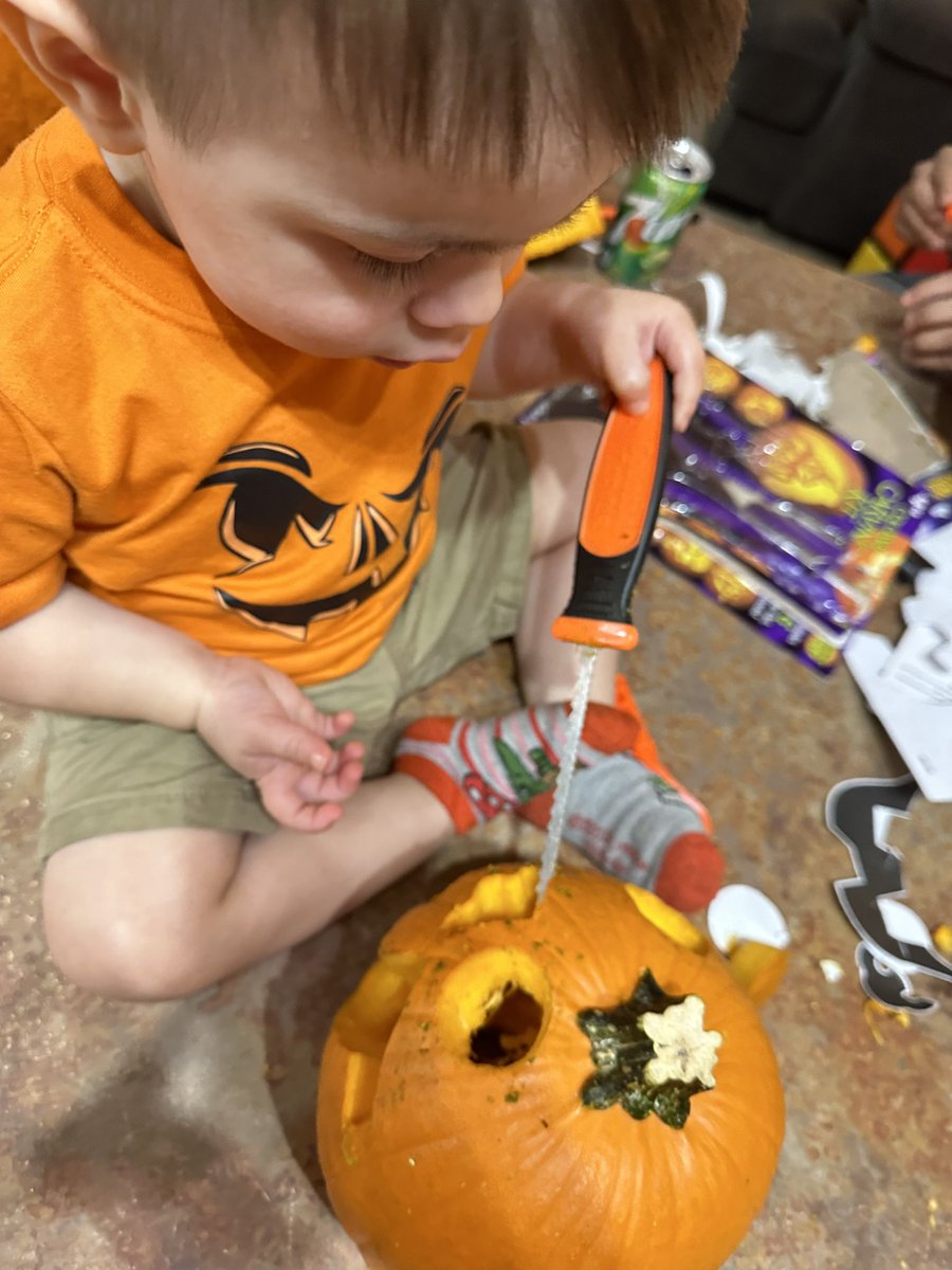 Maxi carving a pumpkin
