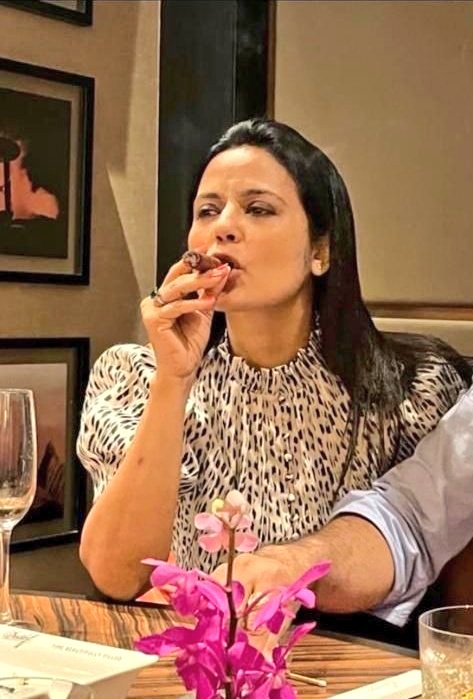 NewsSquare4's tweet photo. What's so wrong in these pics of Mahua Moitra! It actually resonates with TMC's slogan - Ma, Mati, Manush - with just a little tweaks. Ma-al (drinks), Mati (tobacco is grown on soil) &amp; Manush (Man-hus). And STOP trending #HaramiMahua you uncultured people. https://t.co/gaZiew8aVa