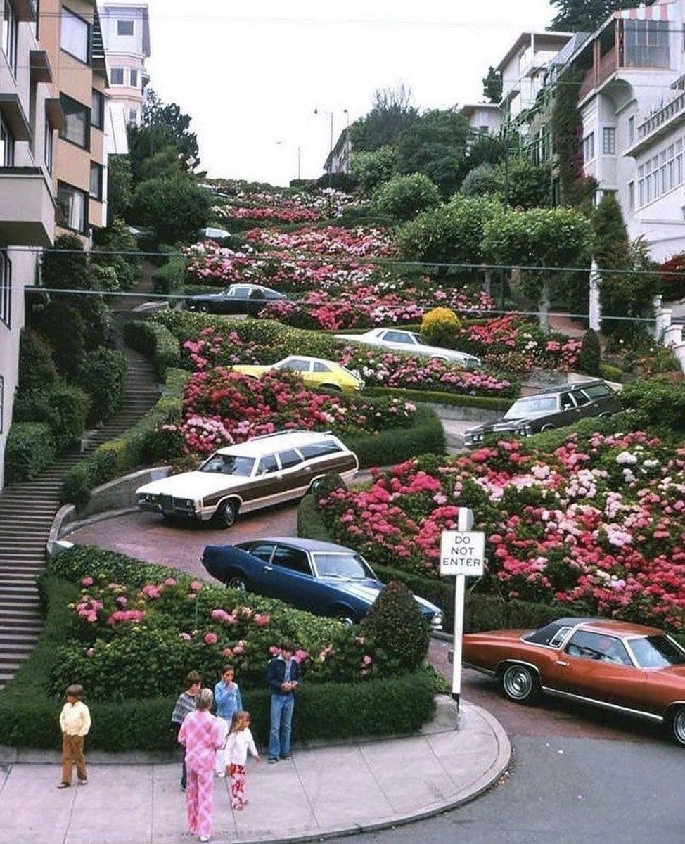 San Francisco's Lombard Street, captured in 1975, is renowned as the 'Crookedest Street in the World' and stands as one of the city's most iconic attractions. Each year, countless tourists either stroll or drive along its eight sharp hairpin bends. This street is also celebrated