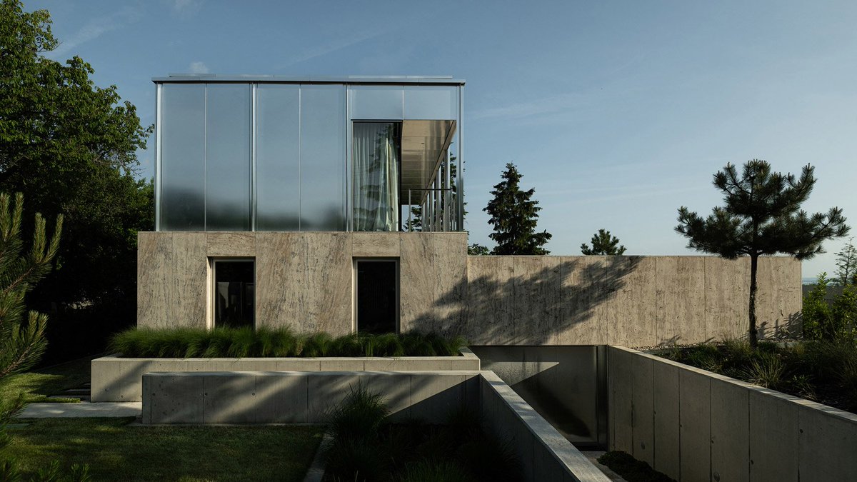 dezeen's tweet photo. A limestone plinth supports this Hungarian holiday home by Kontextus Architecture Studio: https://t.co/D13cH16qNT https://t.co/YUsOgx35jY