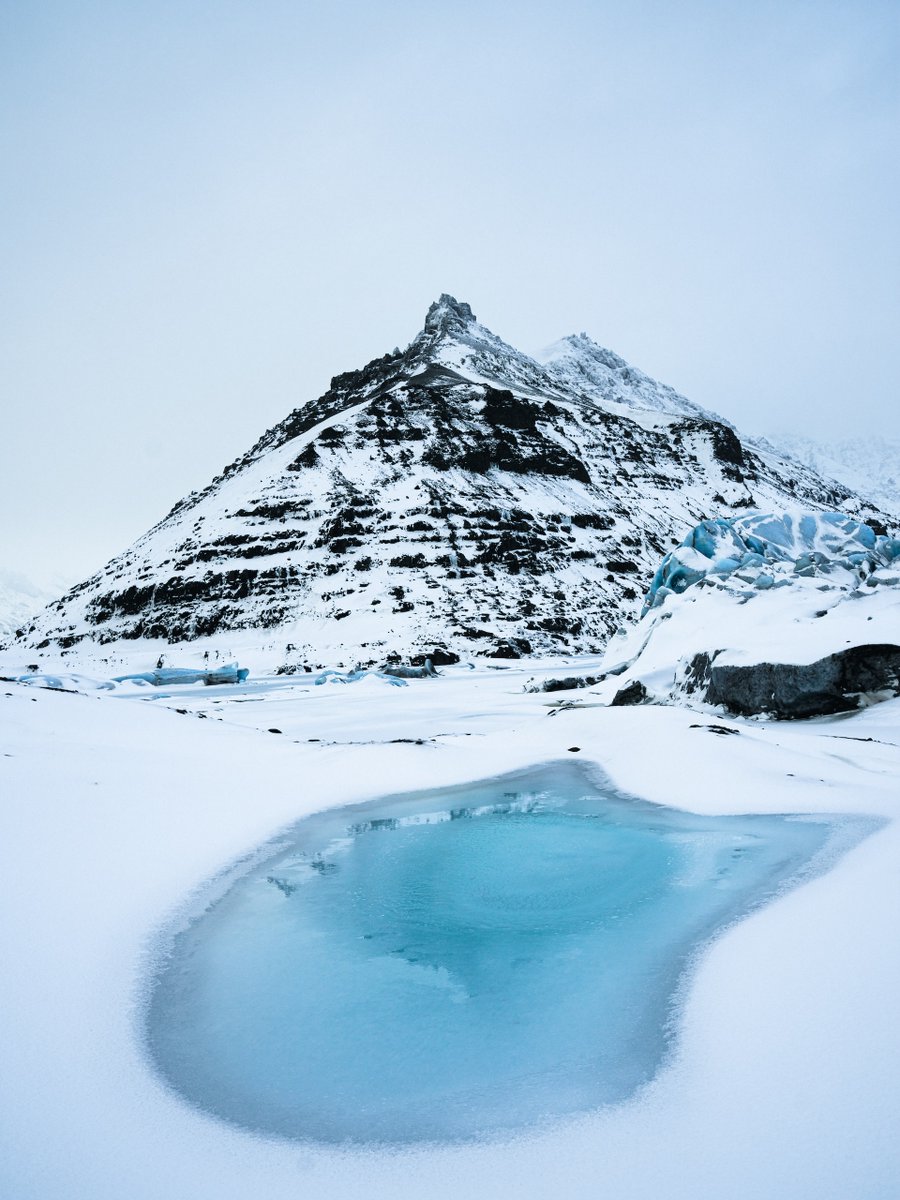 Embracing the serene beauty of Iceland's winter wonderland. ❄️ Where snowy peaks meet crystal blue, and nature's tranquility speaks volumes. What's your favorite winter escape? 🏔️