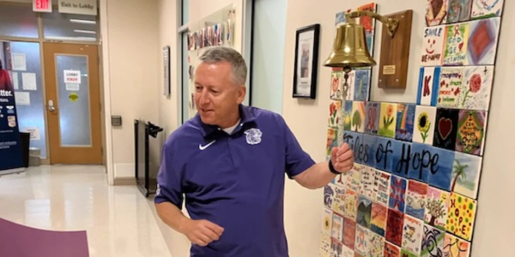 President Linton rings a bell after completing his last cancer treatment.