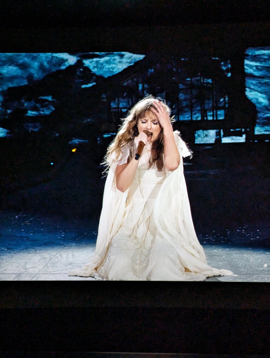 UnWantedCake's tweet photo. Watched the Eras tour showing yesterday and I'm still obsessed with this white dress sleeve cape that Taylor has. 🙈 https://t.co/r7aiyJoXtl
