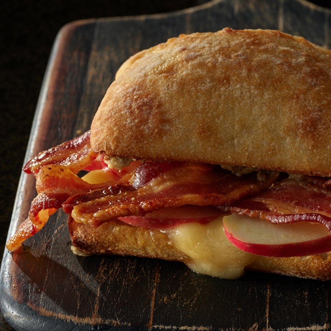 Elevate your lunch game with a symphony of flavors! 🥪🥓🍏 Indulge in our Bacon, Apple, and Brie Sandwich – made with limited time only HORMEL® BLACK LABEL® Apple Cider bacon. It's a taste sensation that'll leave you craving more! 🥓🧀🍎