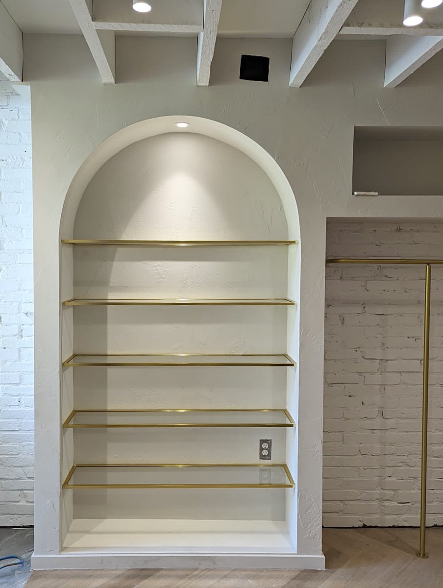 DoorsandMore's tweet photo. Glass shelves were required for a new retail location. The client requested they be framed in Satin Brass which defined the glass and added some colour to the cabinet. Matching the fixtures in the space, the framed shelves are a gorgeous addition. https://t.co/VoveOtH7xR