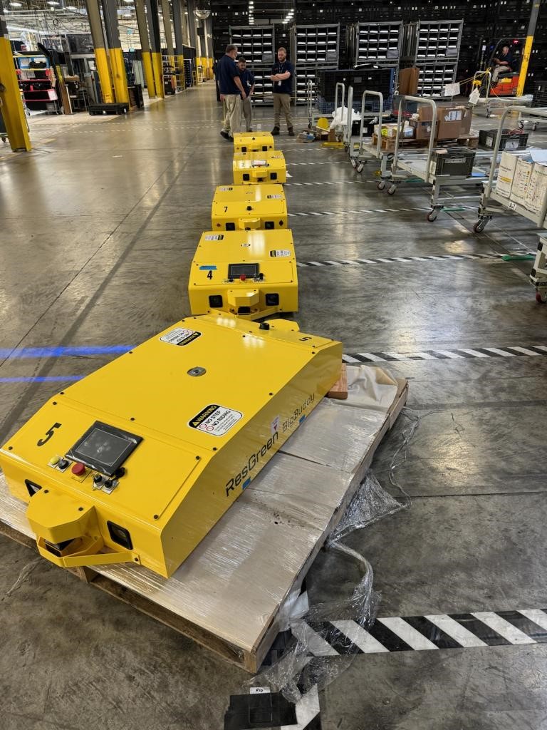 ResGreenGroup's tweet photo. $RGGI is working hard to install 10 BigBuddys at our customer's plant in Ohio. Our staff is installing hundreds of feet of magnetic tape, several automatic charging stations and dozens of tags that are used to assign tasks to the #AGVs. It's exciting to see it all come together! https://t.co/pUEaRa1dVF