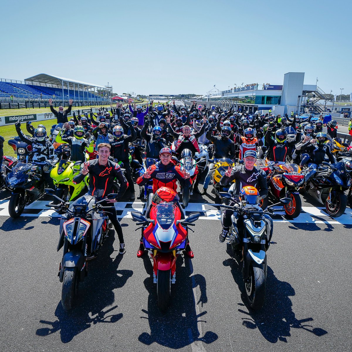 MotoGP's tweet photo. Revs up on the road to Phillip Island, with @marcmarquez93 leading the convoy! 🏍️💨 

What a spectacular way to kick off the #AustralianGP 🇦🇺 weekend!🔥 

#MotoGP https://t.co/RH9upT3xnm