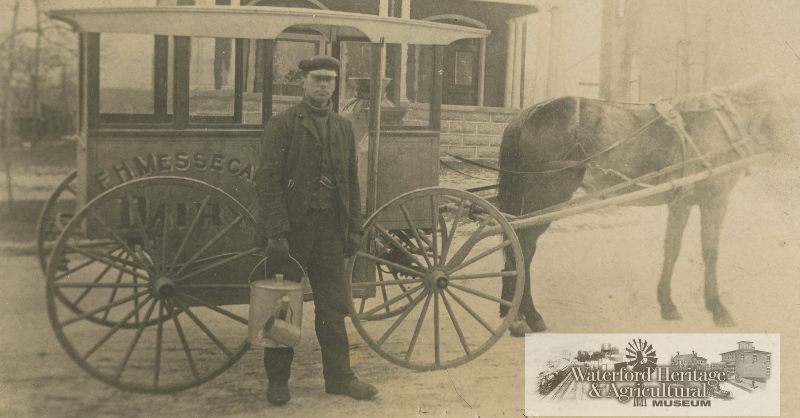 Postcard features a gentleman in front of a E.H. Messecar Dairy horse-drawn buggy. "E(?)er Snively's father Wallace Snively bought the dairy for E. H. Messecar (Ada's father) 1907. Dudley Snively delivered milk in Waterford - Picture taken after 1910"