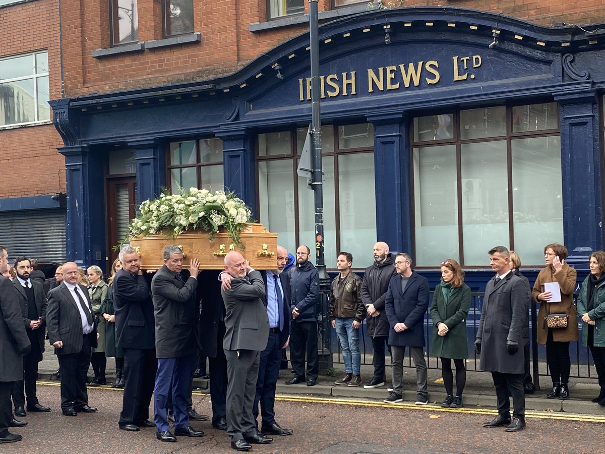 Mourners carrying the coffin of photographer and boxer Hugh Russell pause for a few moments outside the former offices of The Irish News in Belfast today. A fitting tribute to a lovely man who will be missed by so many people <a href="/irish_news/">The Irish News</a> #hughrussellRIP