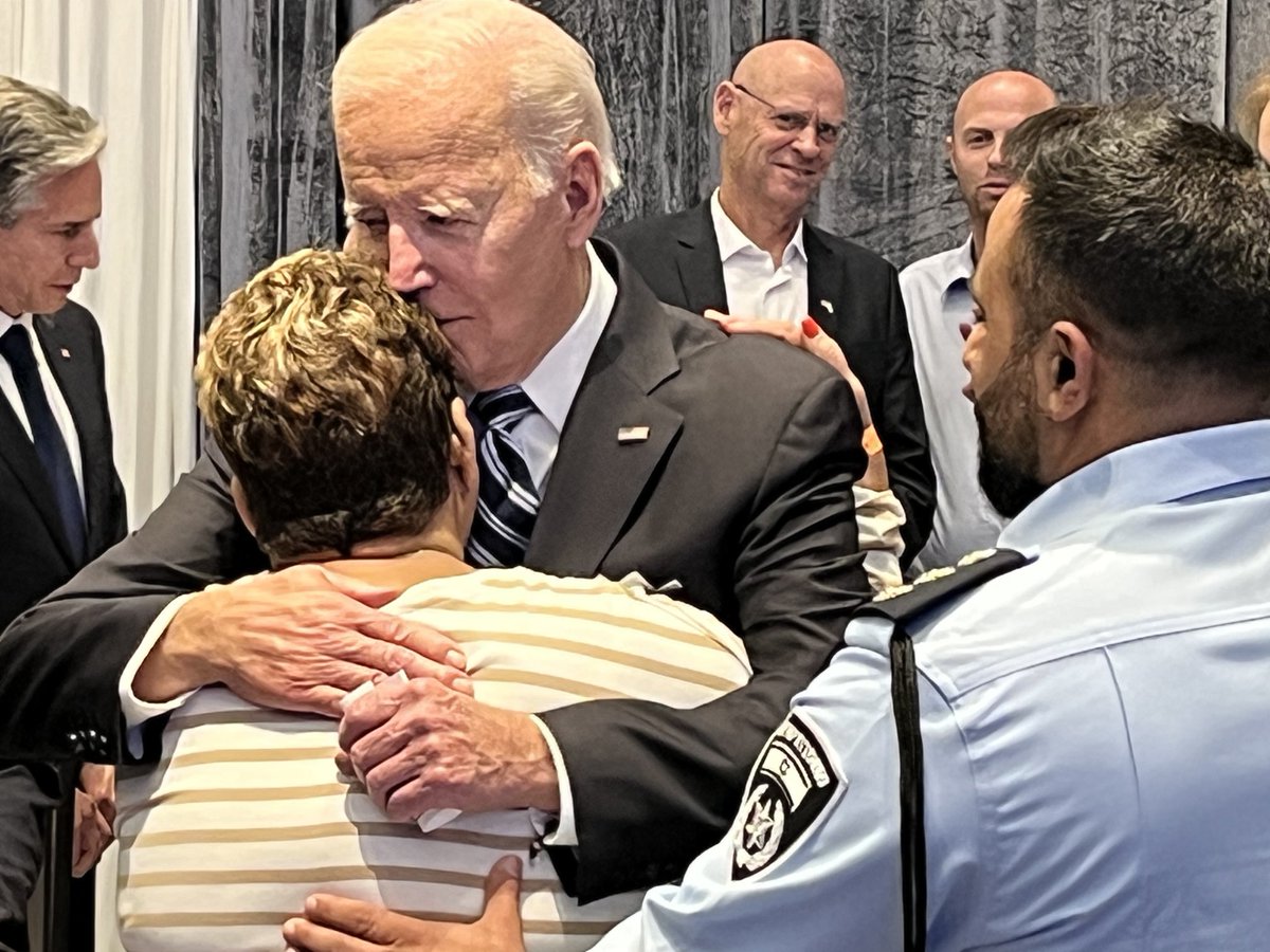 peterbakernyt's tweet photo. Biden hugs Rachel Edri, an Israeli woman who was held hostage at gunpoint in her home for 20 hours and used food and conversation to keep her capturers calm until she could be rescued. https://t.co/ub5TUogQez