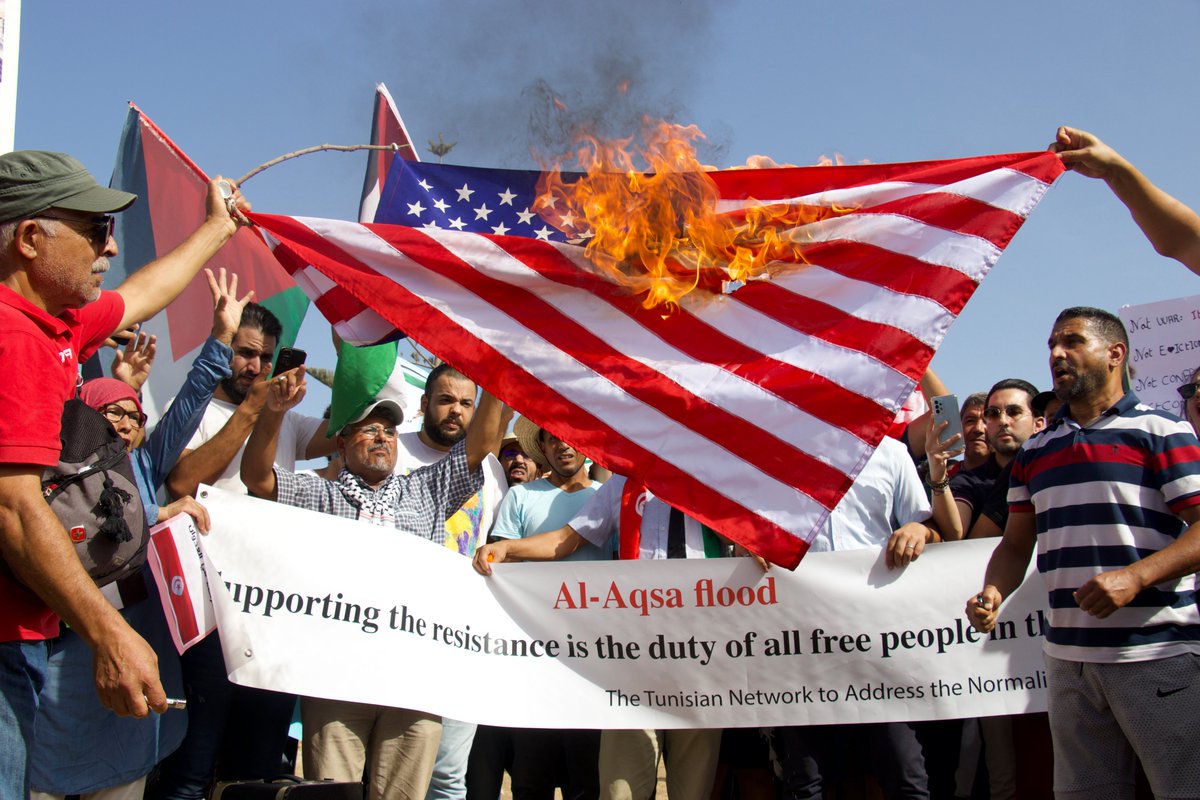 Outside US Embassy in Tunis, Tunisia this morning, demonstrators supporting Palestinian resistance and denouncing Israeli war crimes burn the US flag. Photo by <a href="/ShahdLina/">Chahd lina شهد لينا</a>