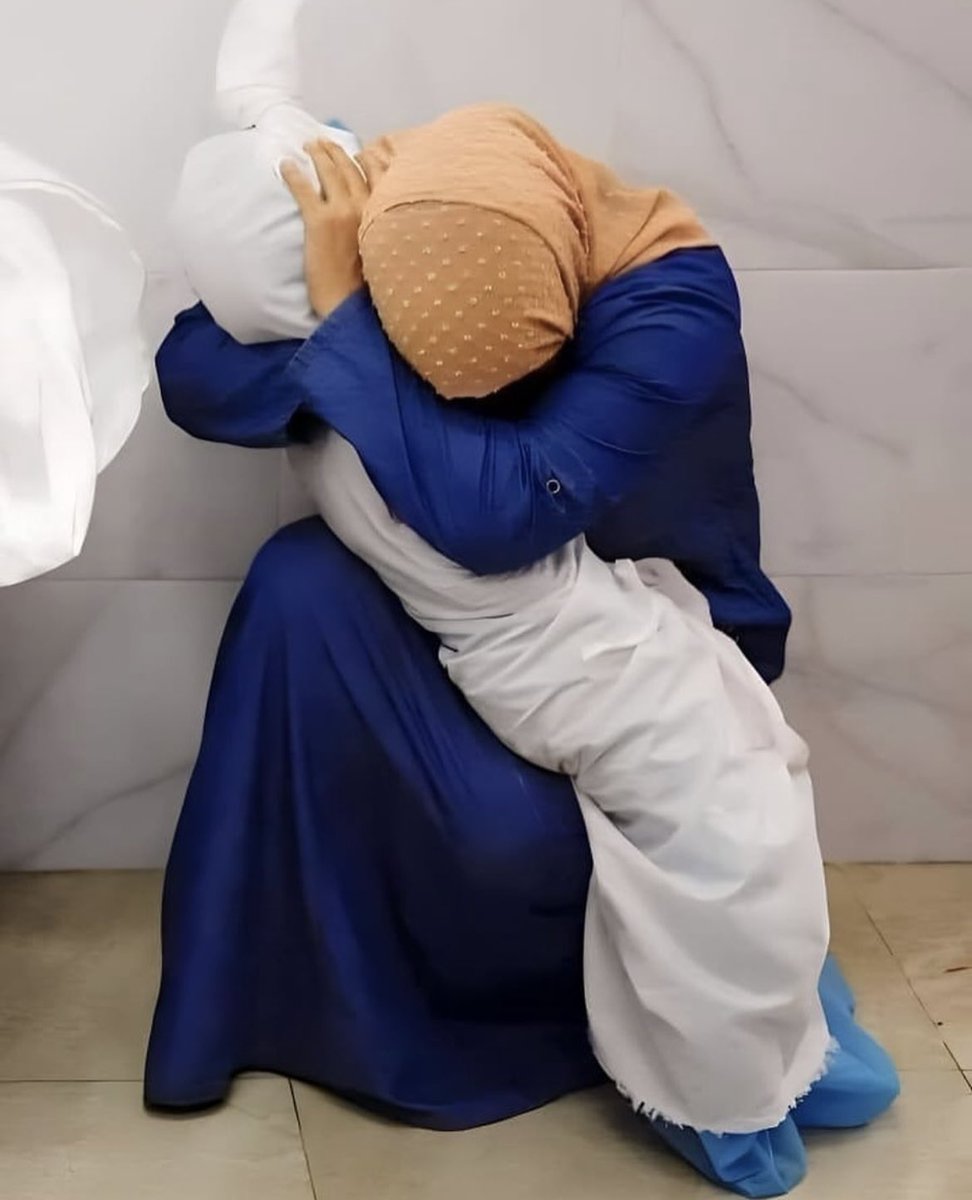 KhaledBeydoun's tweet photo. A mother embraces the body of her dead son. And they call us “animals.” https://t.co/FyApgIC7Yt