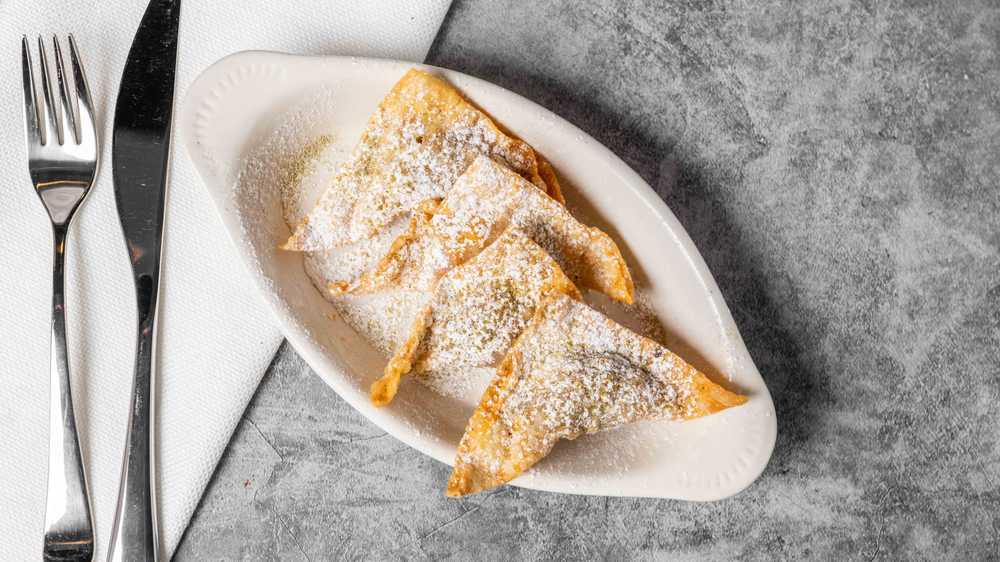 Our sambosa are turnovers that are stuffed with minced beef and lentils, pan fried until crispy, then dusted with powdered sugar and cardamom. It’s a surprising and unique Afghan snack that makes for a perfect appetizer!