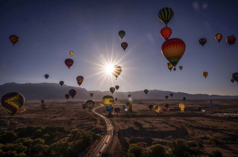 sundaylongread's tweet photo. Defying gravity, Albuquerque Journal photographer @BushChancey gained a soaring vantage point to shoot the Albuquerque International Balloon Fiesta in New Mexico on Oct. 11 by climbing aboard a hot air balloon created by the immersive art experience Meow Wolf. #SundayStill https://t.co/xdbMWOV5Da