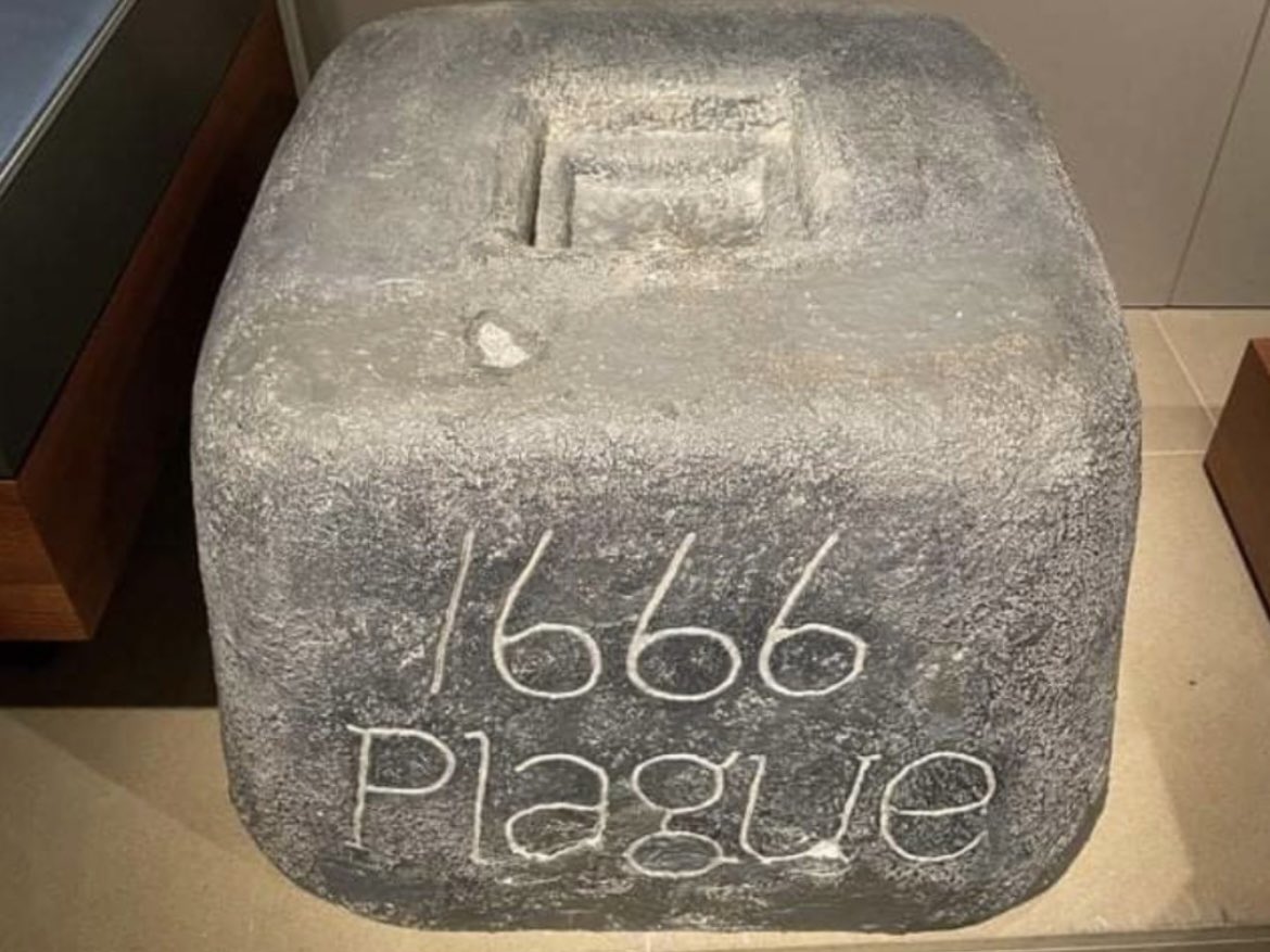 This is a replica of a plague stone from 1666. They were put on street corners, filled with vinegar, and used to wash hands/money. It was the 1600s version of a sanitizing station.